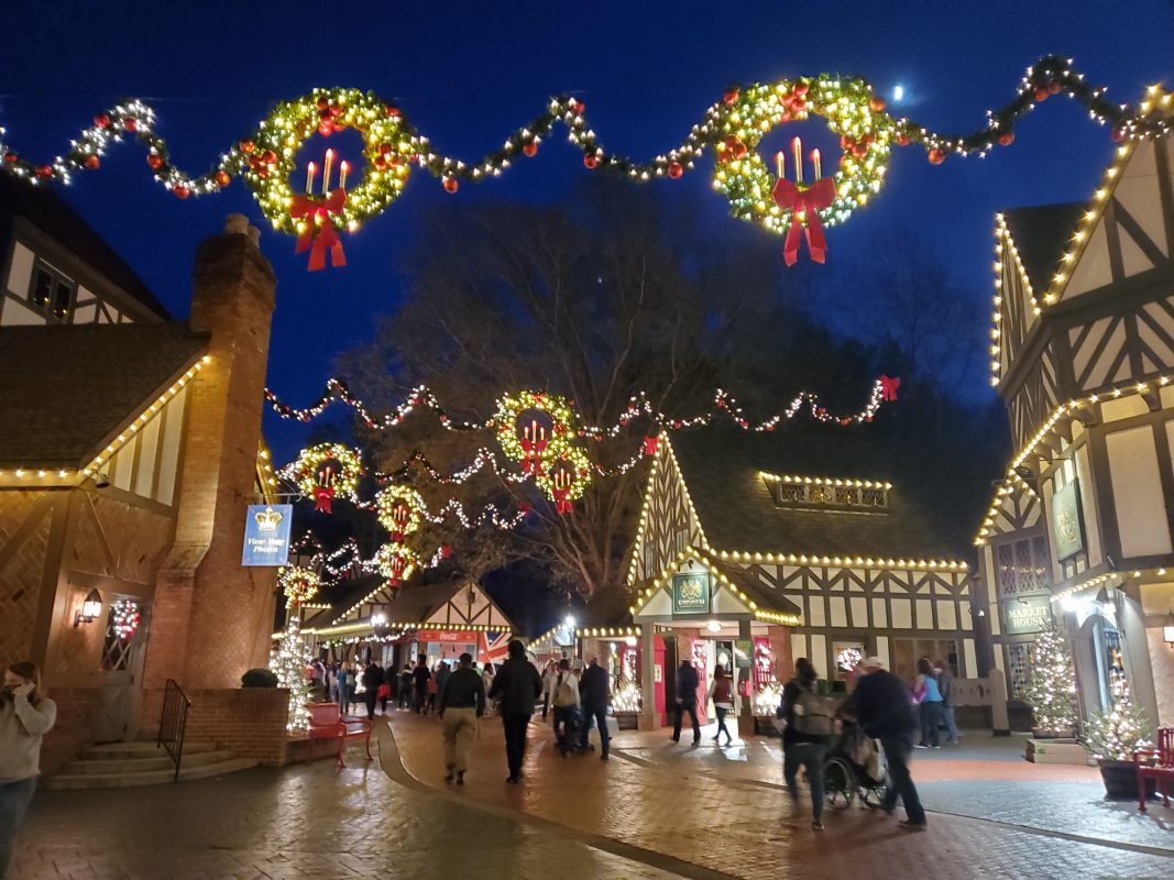 English theme park village decorated with wreaths and holiday lights