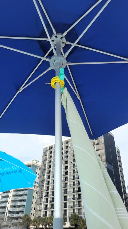 Beach umbrella with a towel hanging from the hook