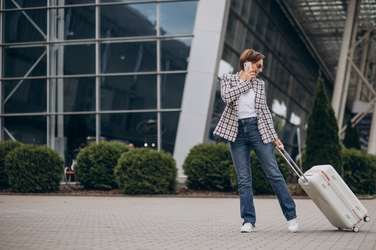 young-woman-with-luggage-airport-travelling-talking-phone